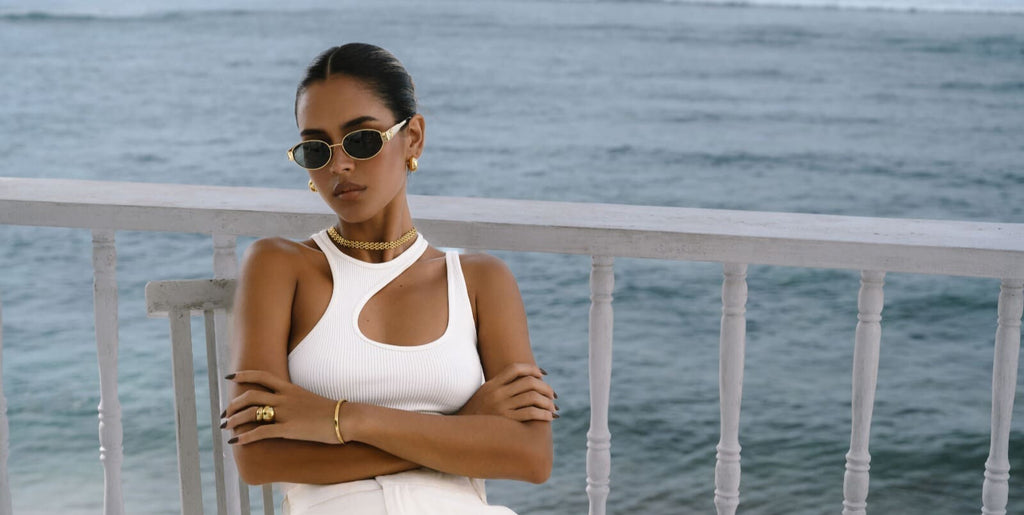 a girl in white vacation outfit wearing gold choker necklace 