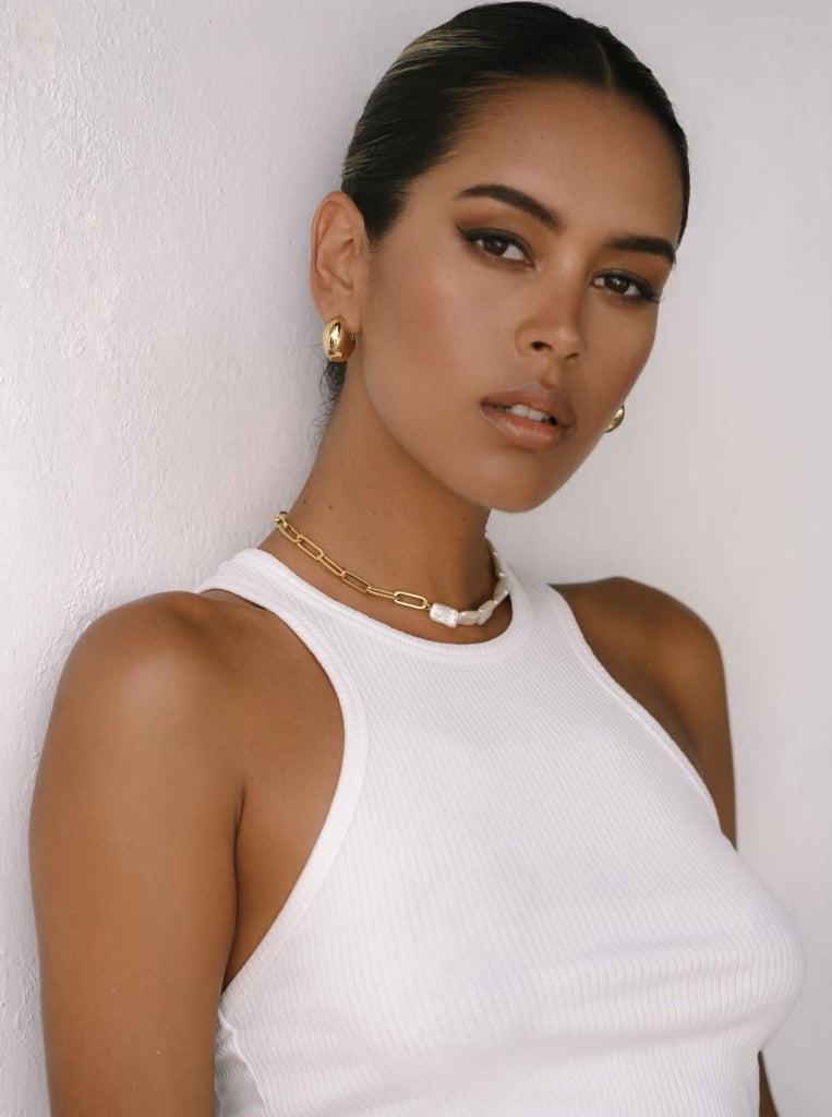 pearl choker styled with white tank top