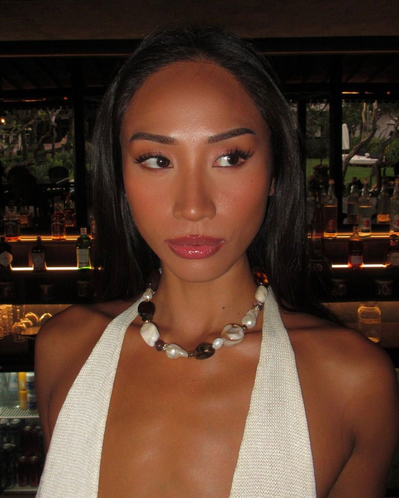 model wearing chunky pearl necklace with crystals and beads