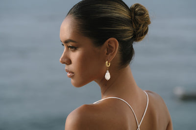 gold pearl earrings with white dress