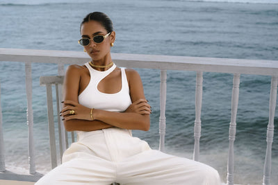gold jewelry set styled with white top and pants