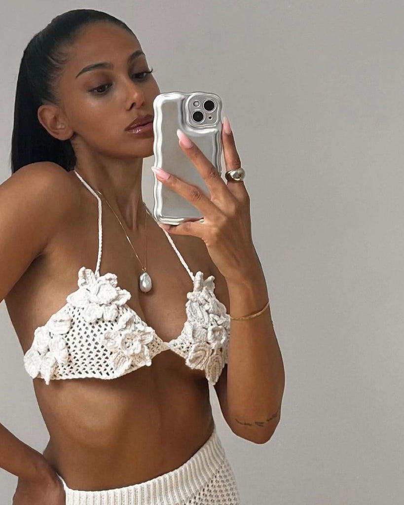 a girl making selfie in knit set and large baroque pearl necklace