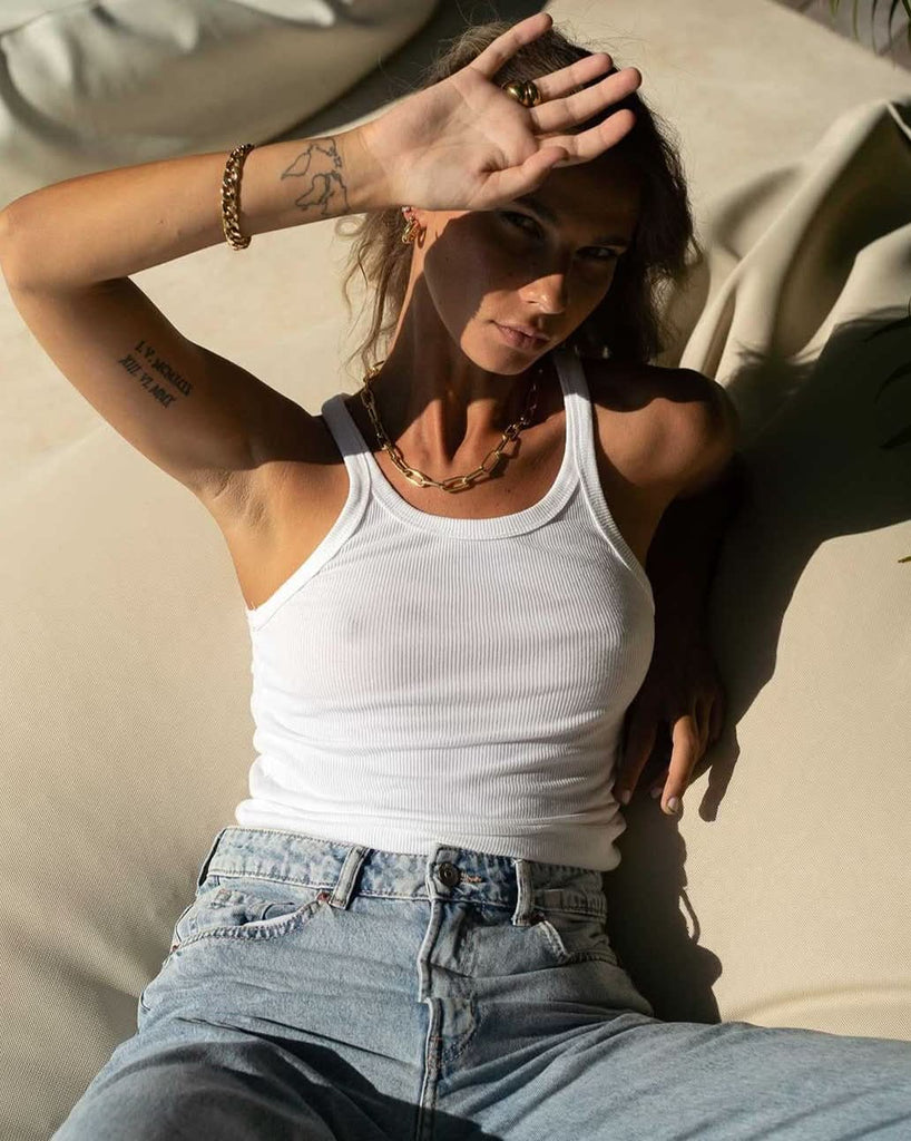 chunky bracelet and necklace styled with jeans and ribbed tank