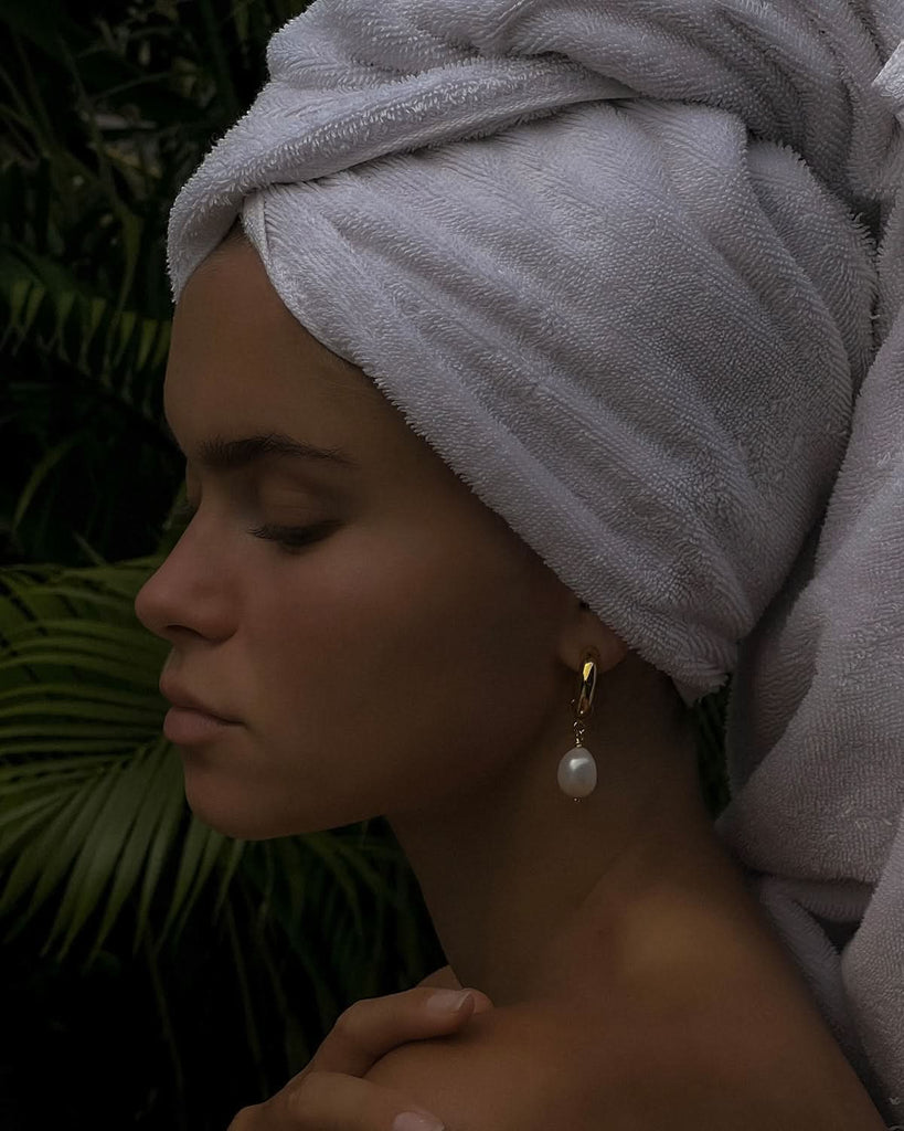 pearl earrings in a dark setting