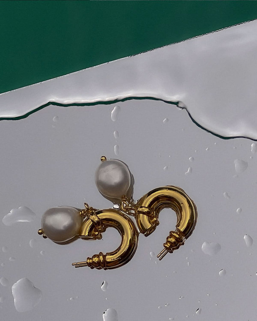 pearl dangle earrings photographed with water drops