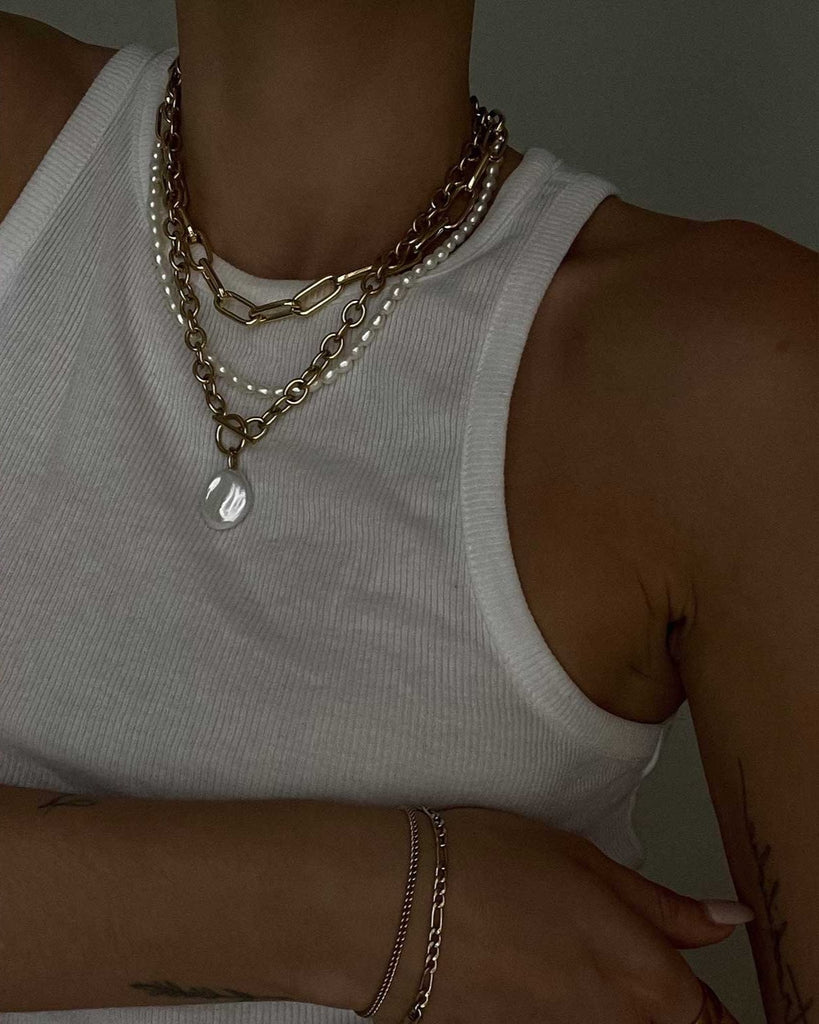 white tank top styled with a pearl necklace set 