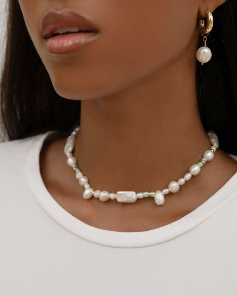 close up on pearl necklace and earrings