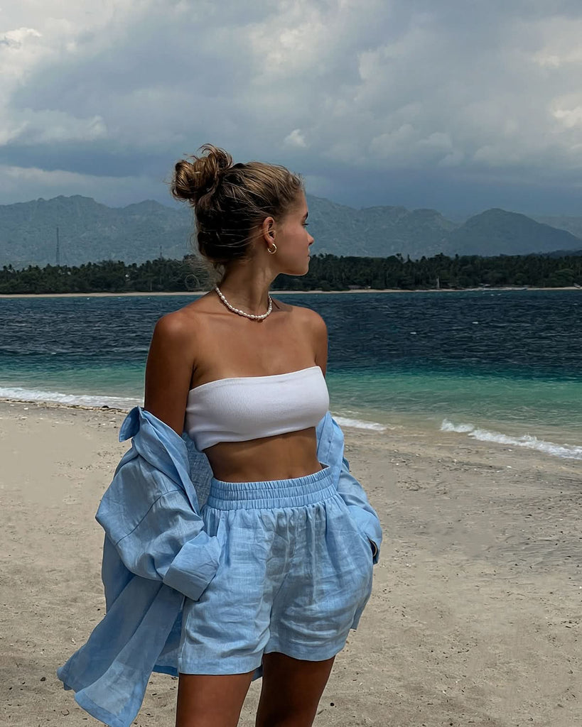 pearl choker worn at the beach with a matching linen set