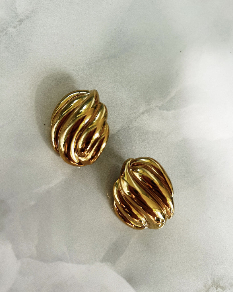 gold statement earrings flat lay photo