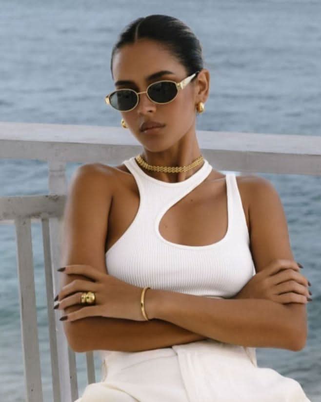 white outfit and gold chunky jewelry