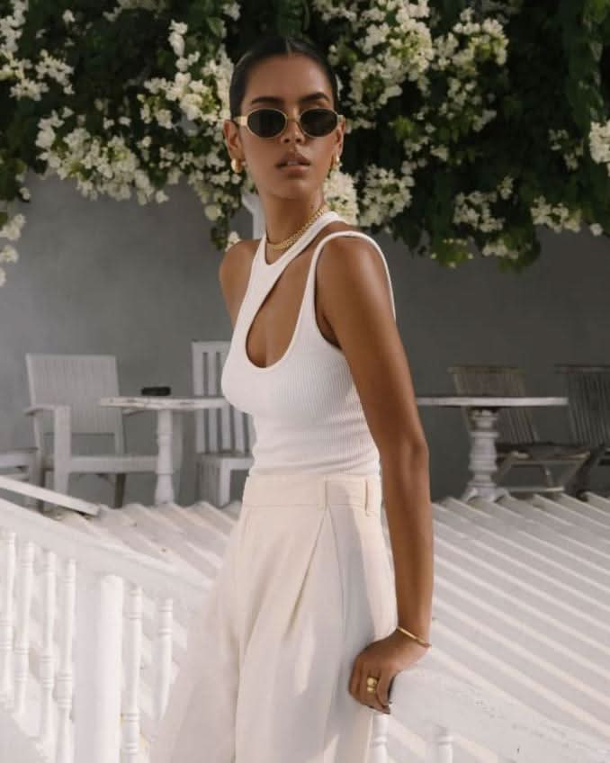 model wearing sunglasses and gold jewelry