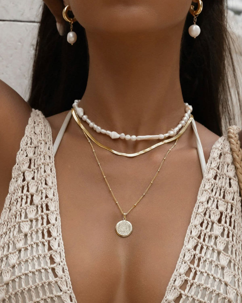 close up on layered pearl necklace

