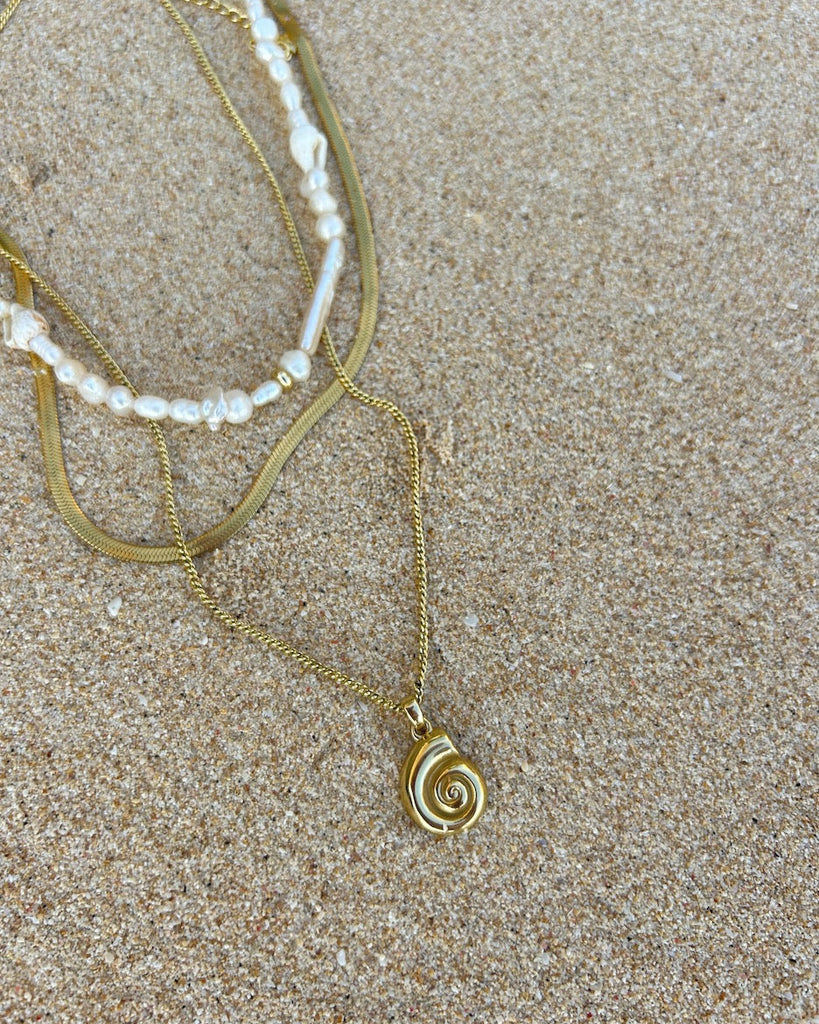 shell necklace gold layered with pearl necklace