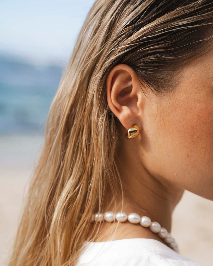 small gold earrings with white tee