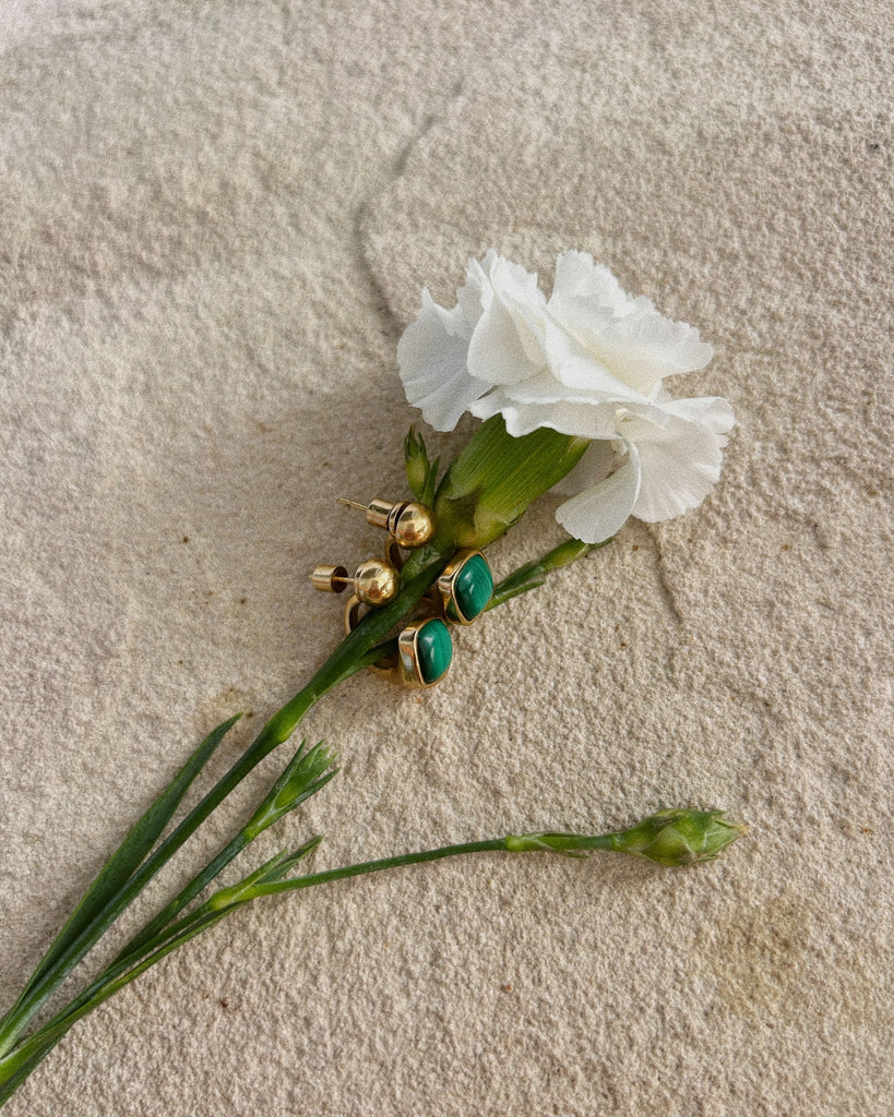 malachite earrings next to the rose