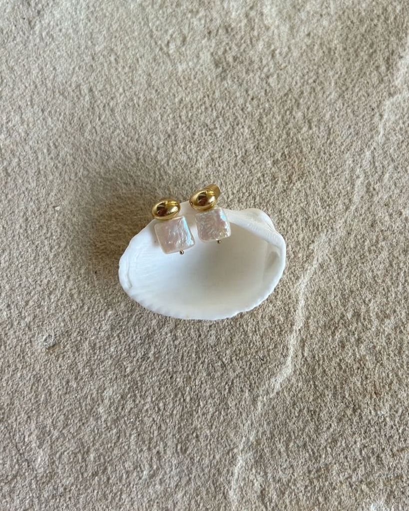 cult of sun pearl studs on a shell