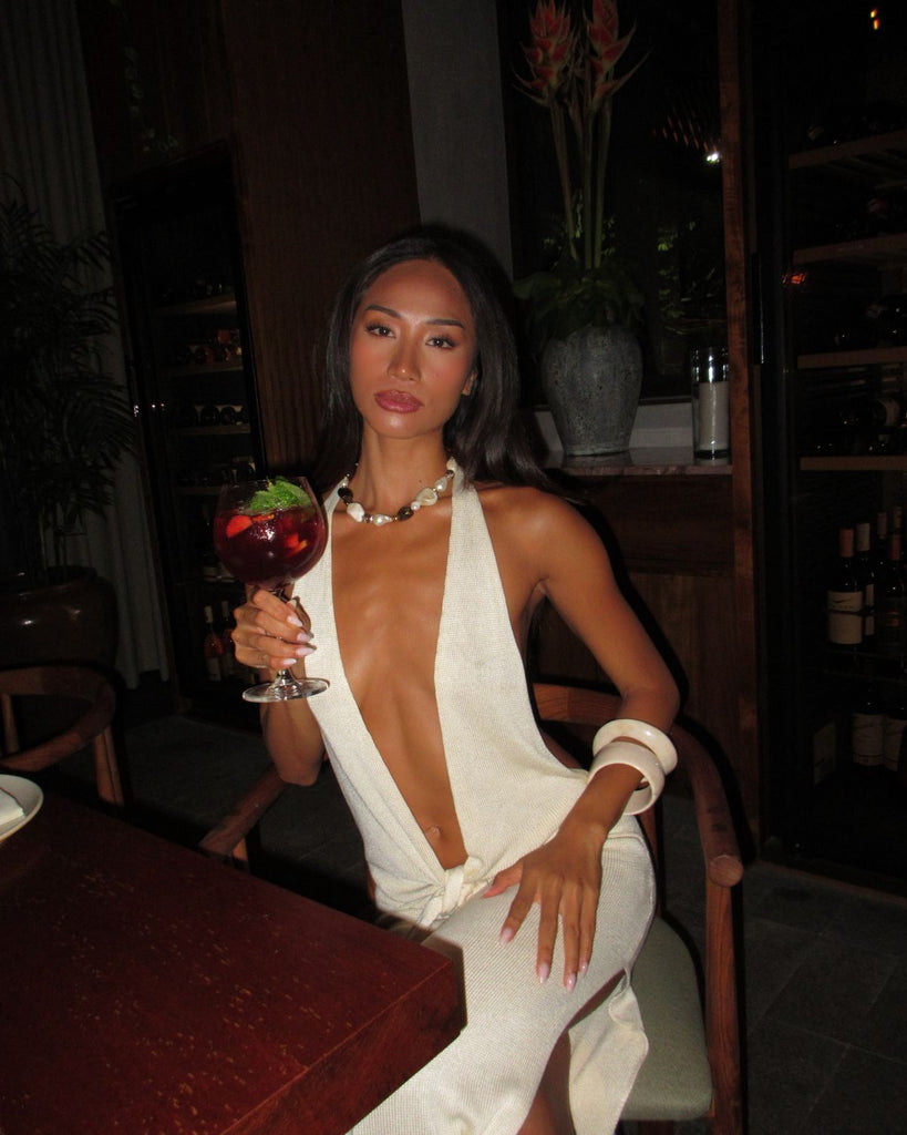 Woman in a white dress wearing chunky bead necklace