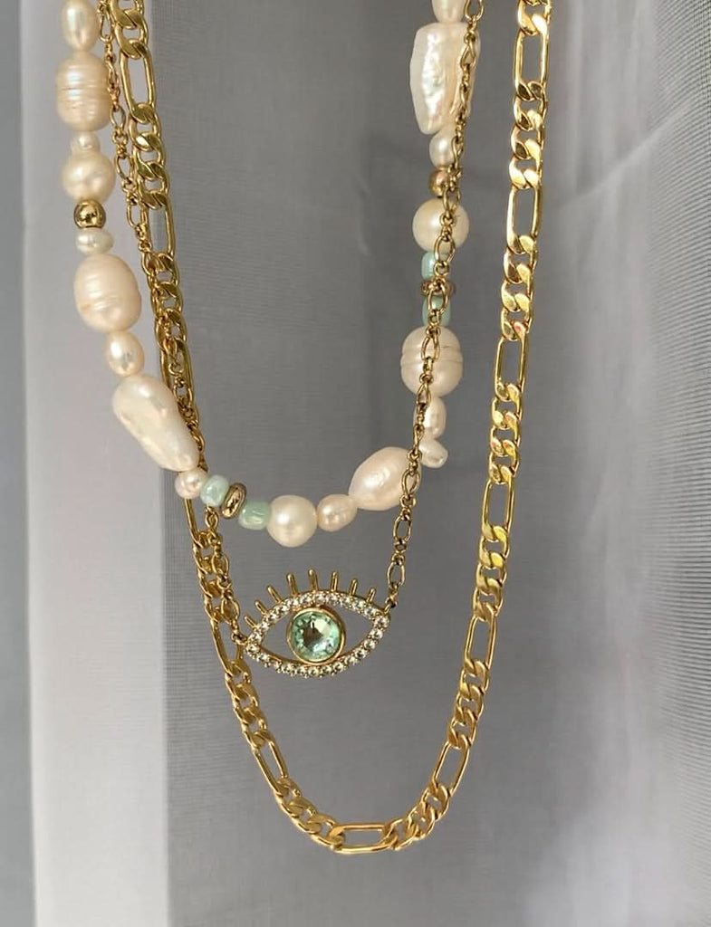 layered necklaces with evil eye gold necklace hanging with pearl necklace