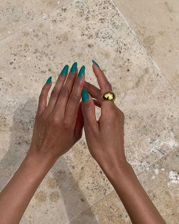 hands featuring a gold thick ring 