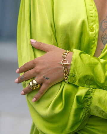 shinny lime dress styled with dome gold rings and bracelet 