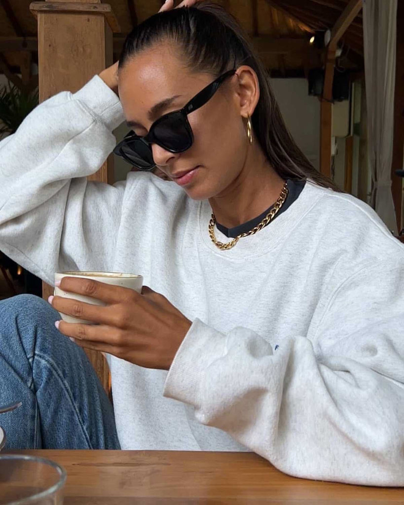 girl showing how to style casual jeans and sweater 