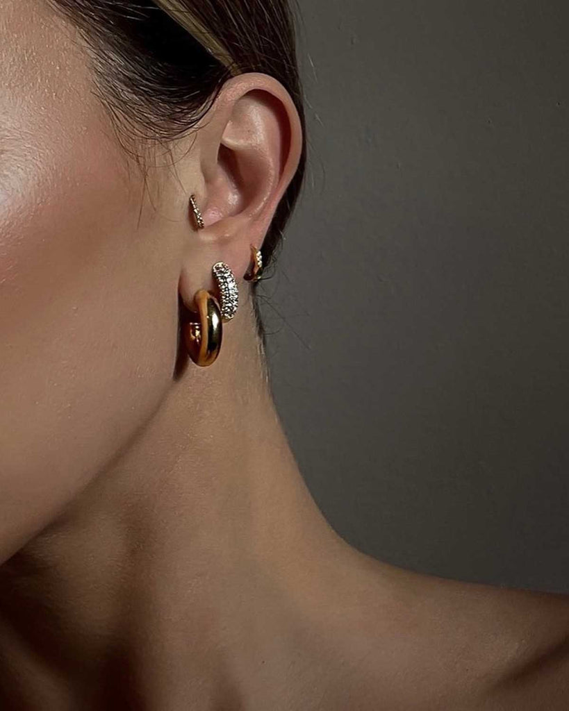 ear featuring three different style of hoop earrings 