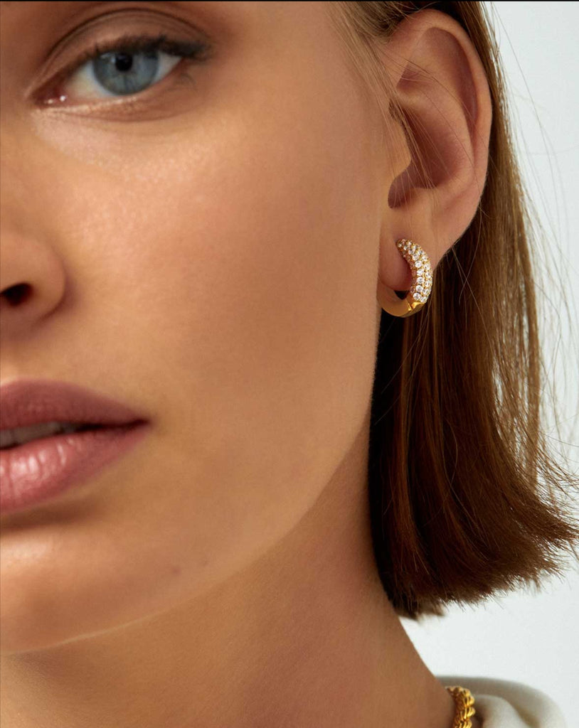 half face of model wearing crystal hoop earring 