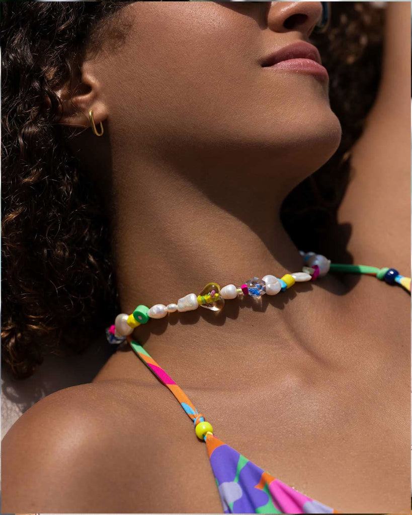 girls neck wearing a colorful choker