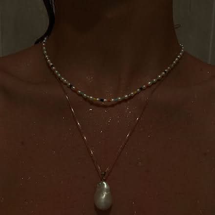 wet neck featuring small and large pearl necklaces 