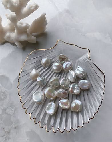 a coral and freshwater pearls on a glass shell plate 