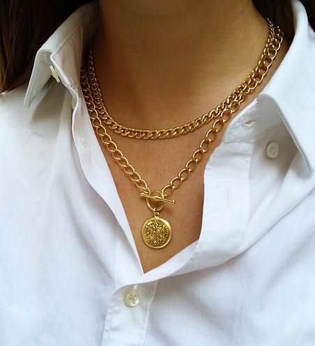 white button up style with two chunky gold necklaces 