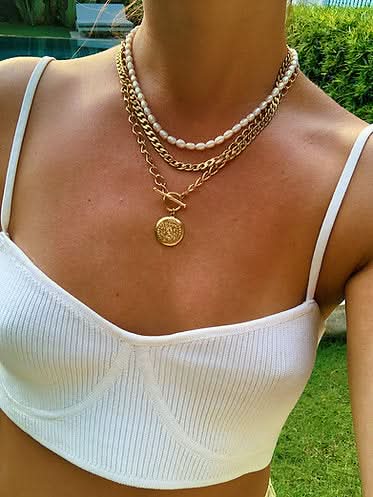 white tank top styled with gold and pearl necklaces 
