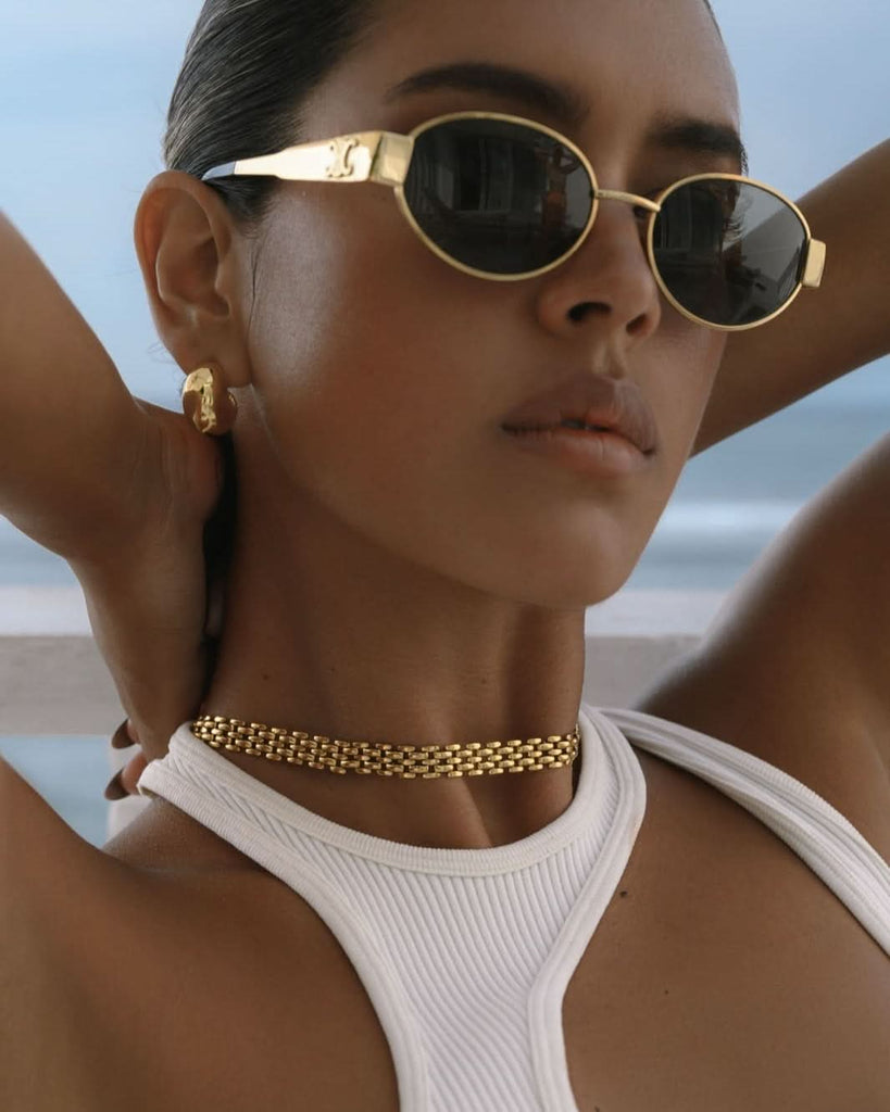 gold necklace and earrings set styled with celine sunglasses